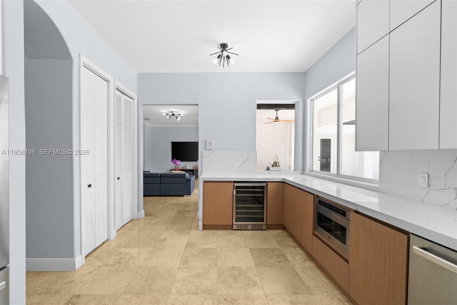16800 Southwest 190th Street Miami, FL 33187 - Photo 15 of 56 a large white kitchen with granite countertop a sink and dishwasher a stove with wooden floors