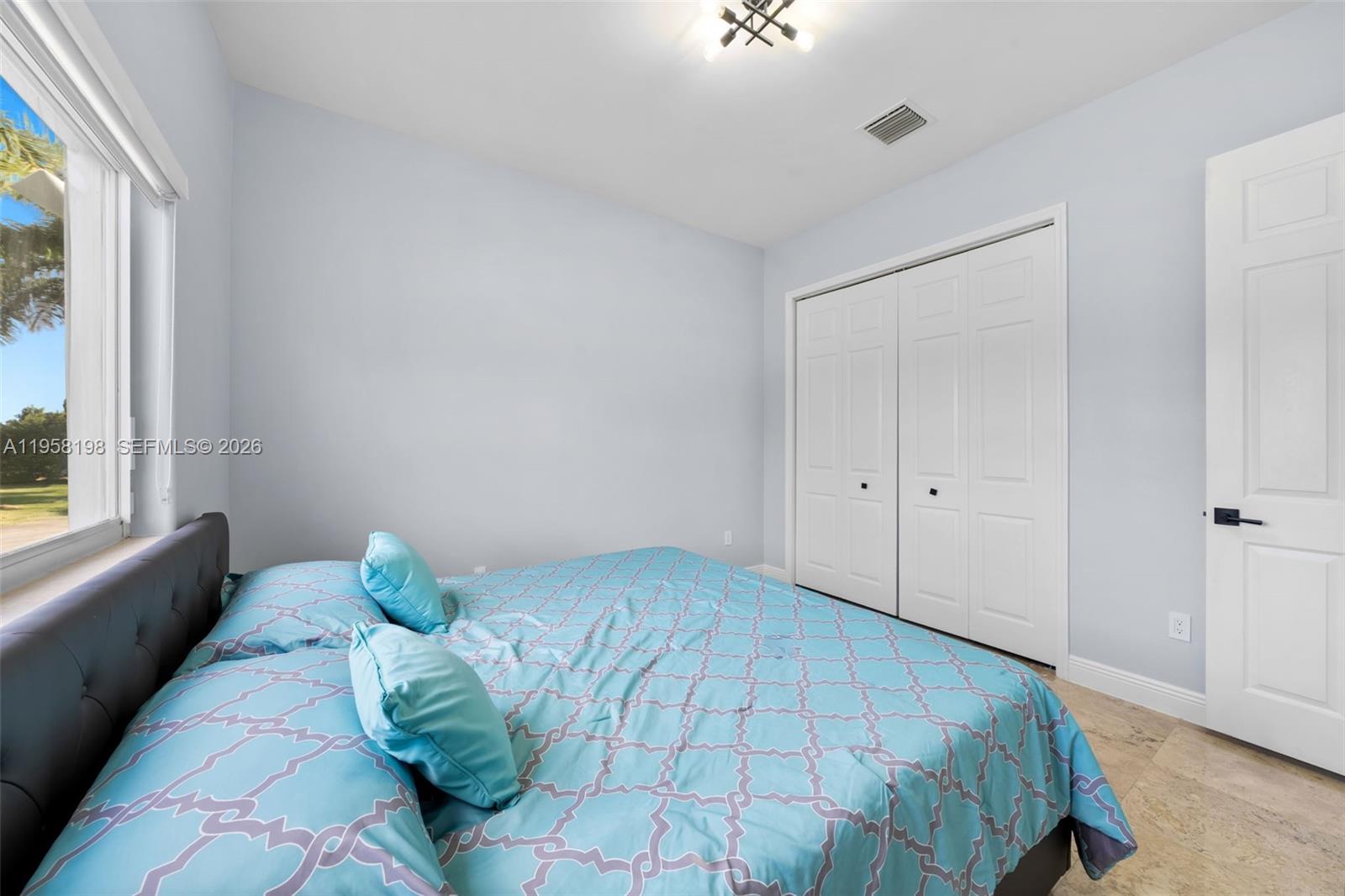16800 Southwest 190th Street Miami, FL 33187 - Photo 25 of 56 a bedroom with a bed and a window
