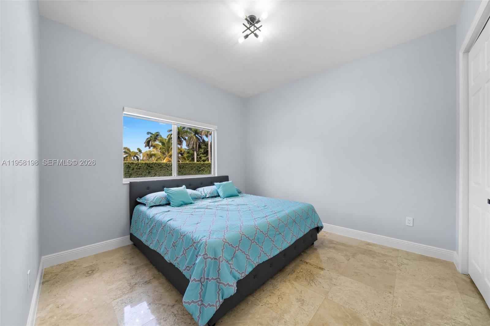 16800 Southwest 190th Street Miami, FL 33187 - Photo 26 of 56 a bedroom with a bed a painting on the wall and a window