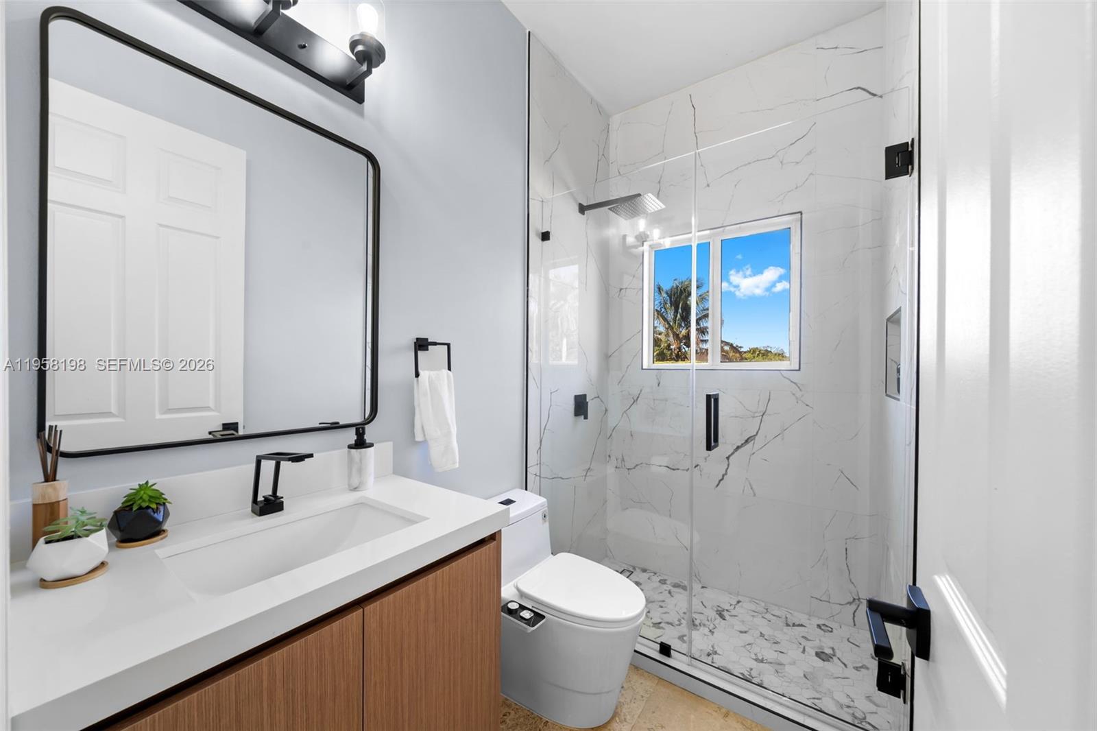 16800 Southwest 190th Street Miami, FL 33187 - Photo 27 of 56 a bathroom with a sink a toilet and shower