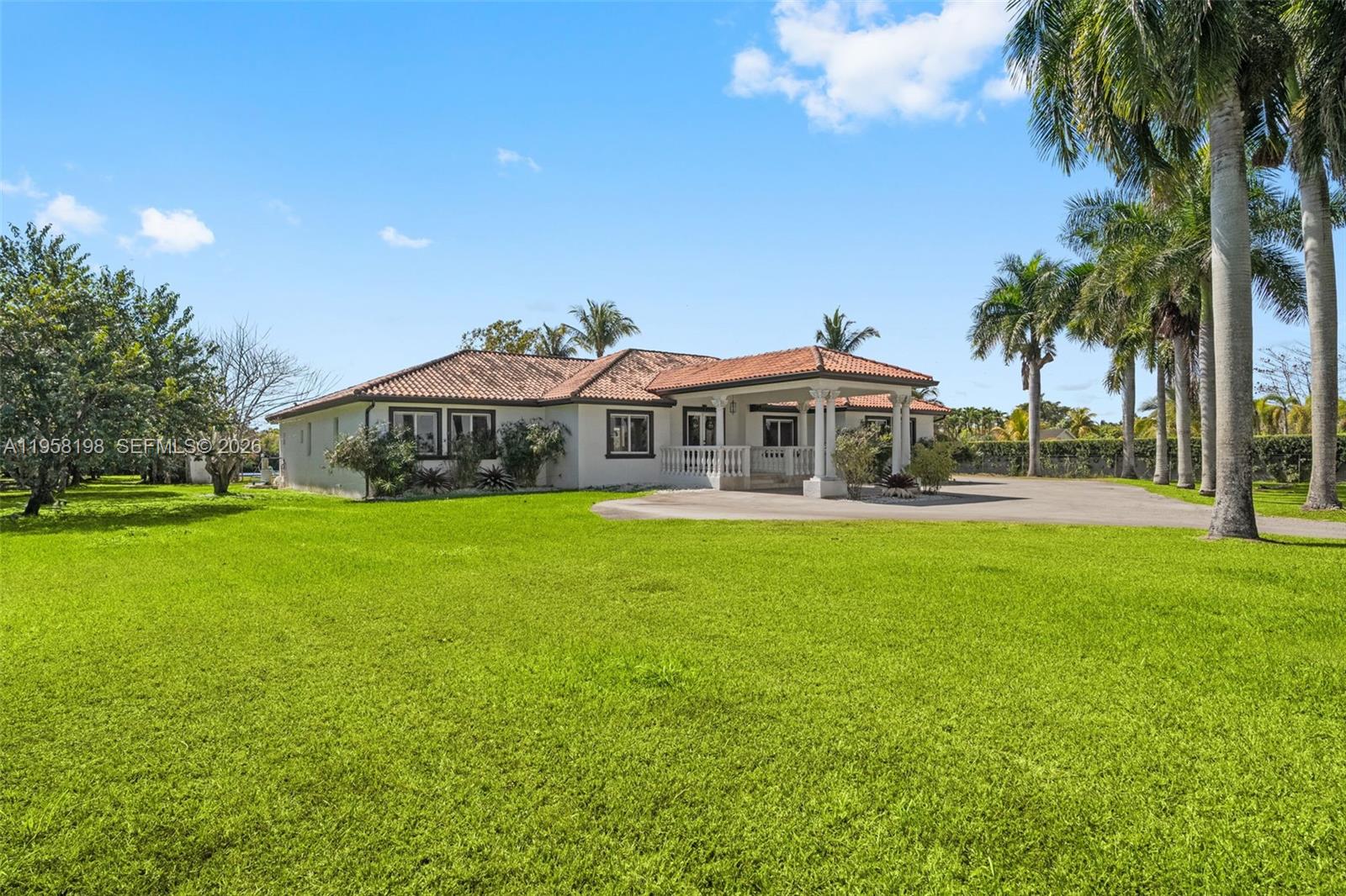 16800 Southwest 190th Street Miami, FL 33187 - Photo 4 of 56 a front view of house with yard swimming pool and outdoor seating