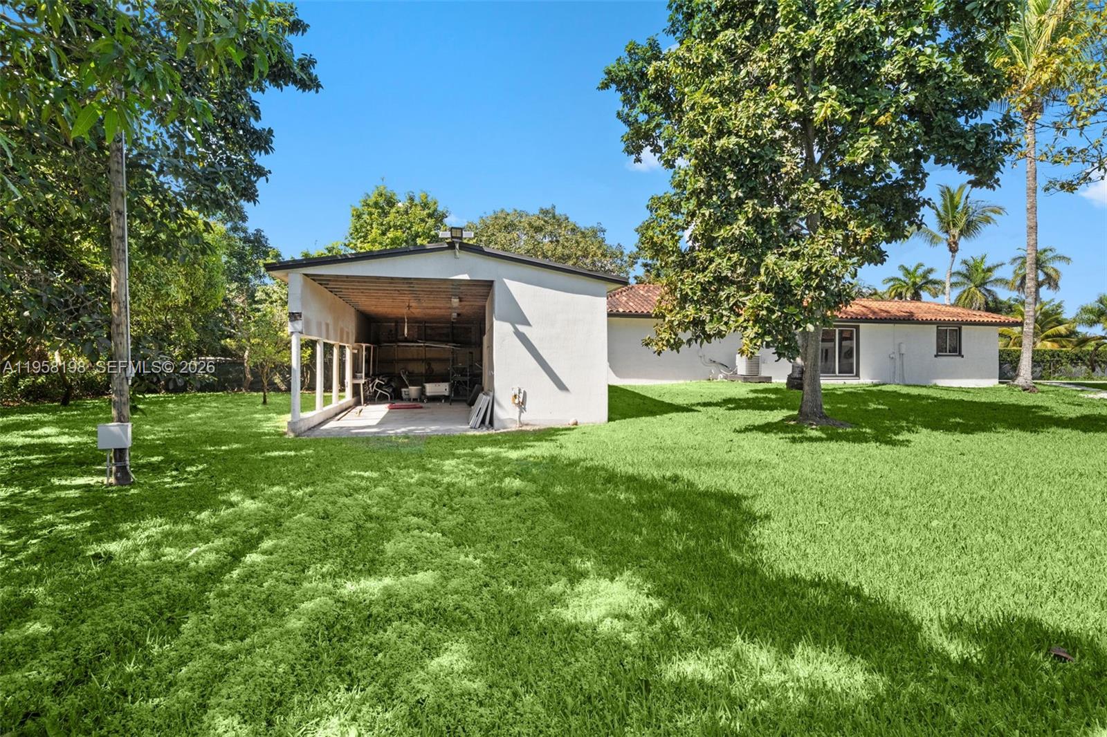 16800 Southwest 190th Street Miami, FL 33187 - Photo 43 of 56 a view of a house with backyard and a tree