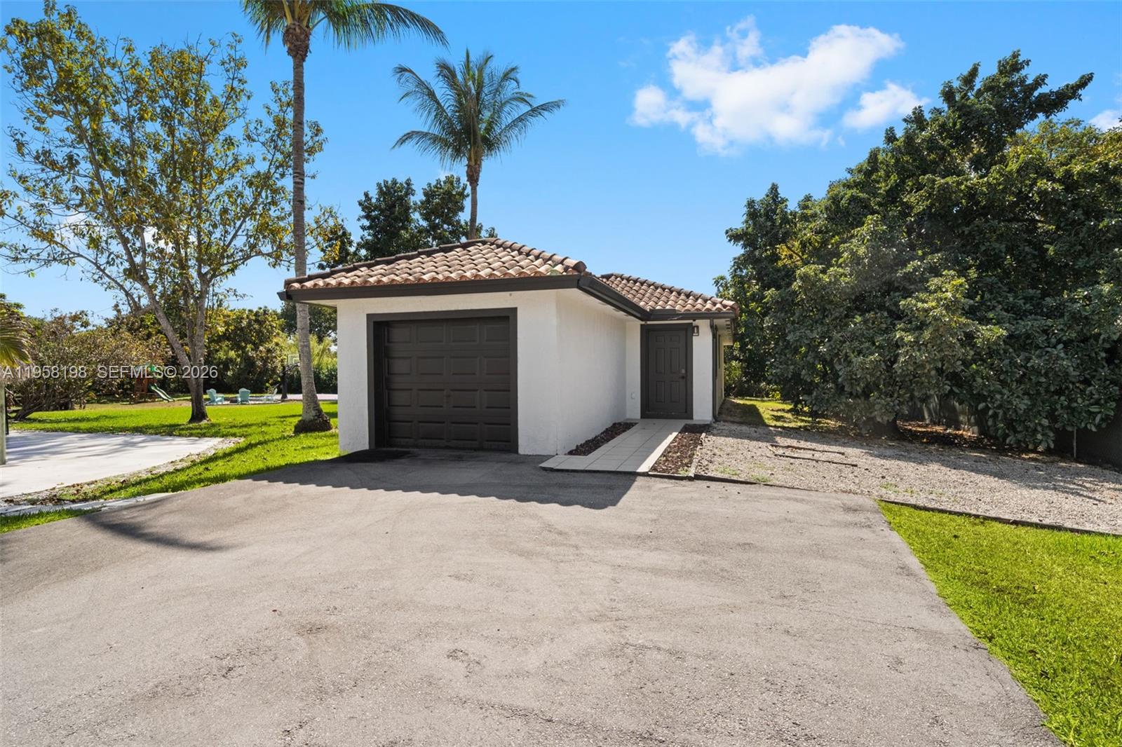 16800 Southwest 190th Street Miami, FL 33187 - Photo 45 of 56 a house with palm tree in front of it