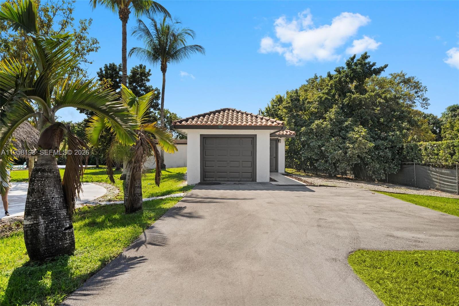 16800 Southwest 190th Street Miami, FL 33187 - Photo 46 of 56 a front view of a house with a yard and garage