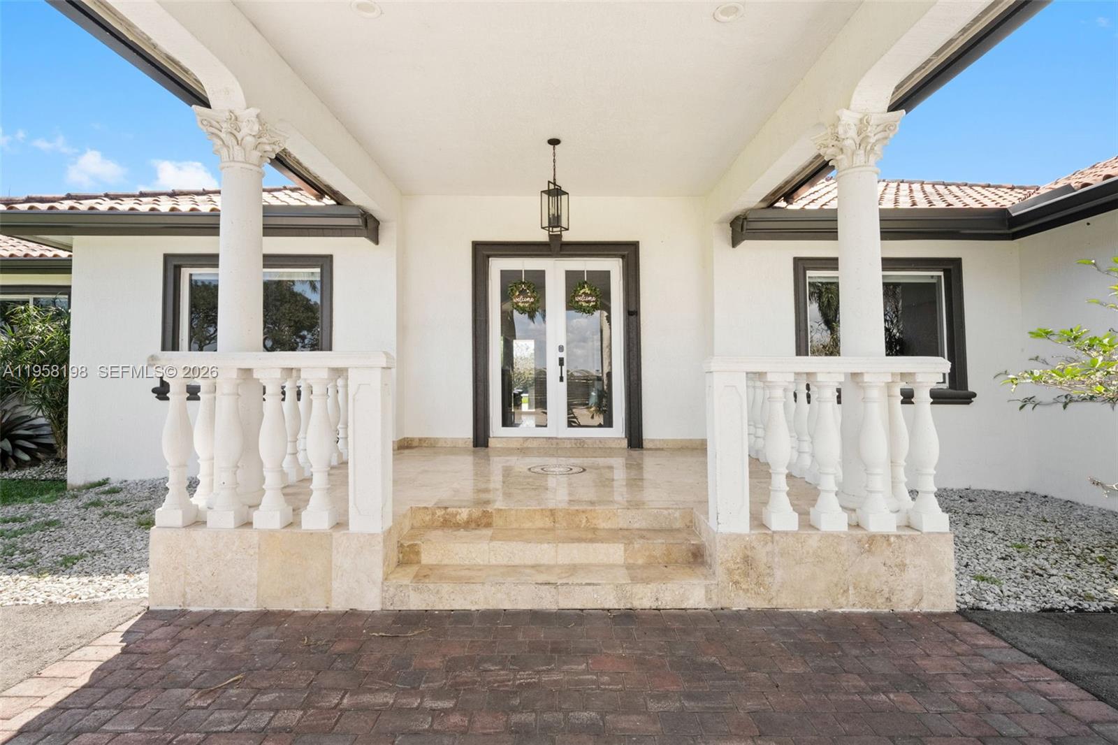 16800 Southwest 190th Street Miami, FL 33187 - Photo 7 of 56 a front view of a house with a yard