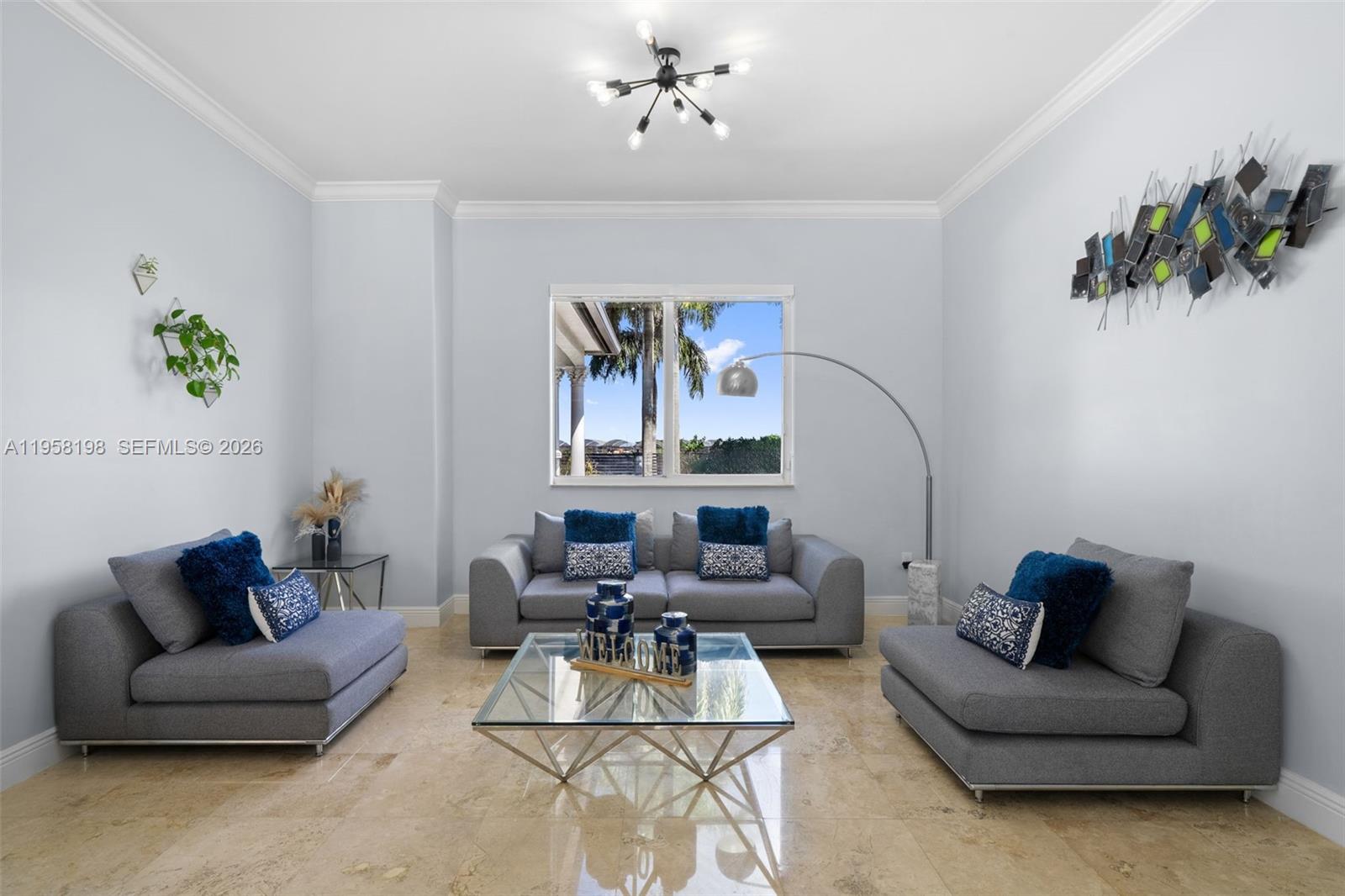 16800 Southwest 190th Street Miami, FL 33187 - Photo 9 of 56 a living room with furniture and a chandelier