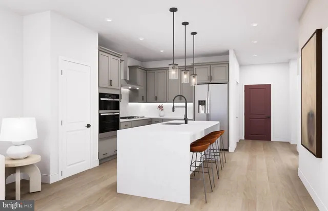 a living room with furniture a refrigerator and kitchen view