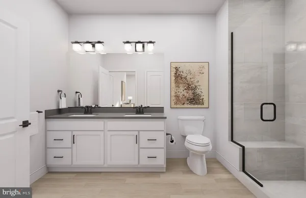 a bathroom with a double vanity sink toilet and shower
