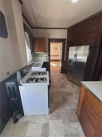 a kitchen with granite countertop a stove and a refrigerator