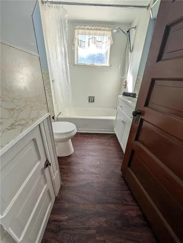 a bathroom with a granite countertop bathtub sink and toilet