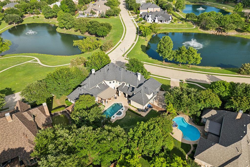 an aerial view of a house with a garden and lake view