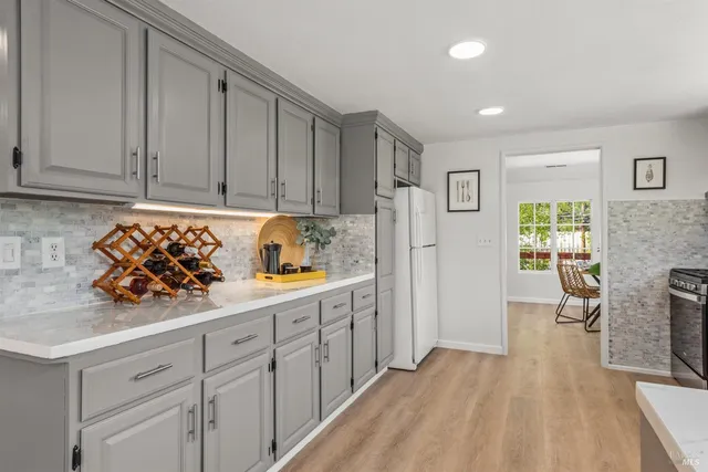 a living room with furniture and floor to ceiling windows