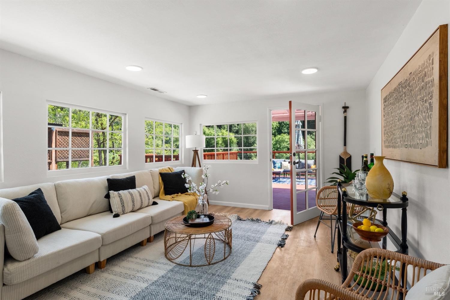 15627 Riverside Drive Guerneville, CA 95446 - Photo 19 of 41 a living room with furniture and floor to ceiling windows