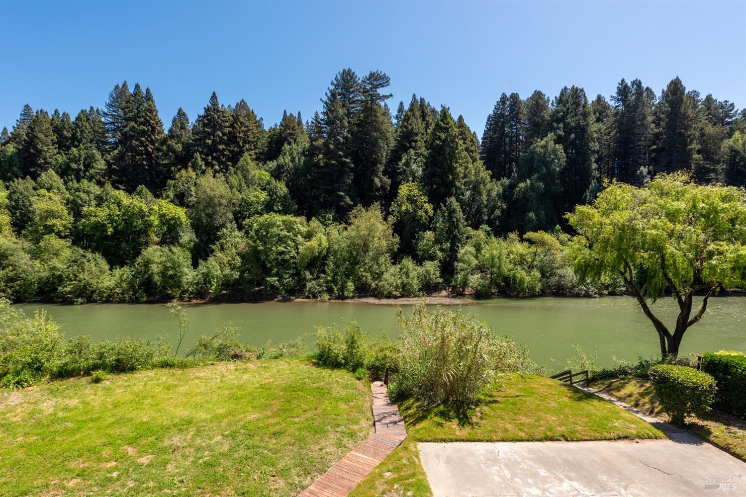 15627 Riverside Drive Guerneville, CA 95446 - Photo 22 of 41 a view of a lake with a mountain in the background