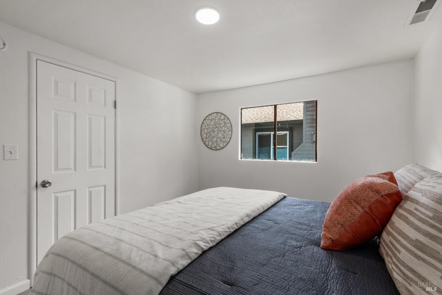 15627 Riverside Drive Guerneville, CA 95446 - Photo 26 of 41 a bedroom with a bed and a window