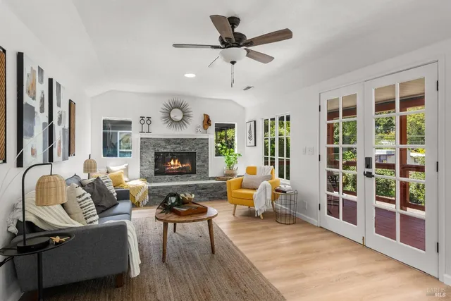 a living room with furniture ceiling fan and a fireplace