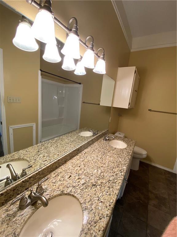 2802 Nueces Street, Unit 311 Austin, TX 78705 - Photo 11 of 13 a bedroom with a bed and a dresser