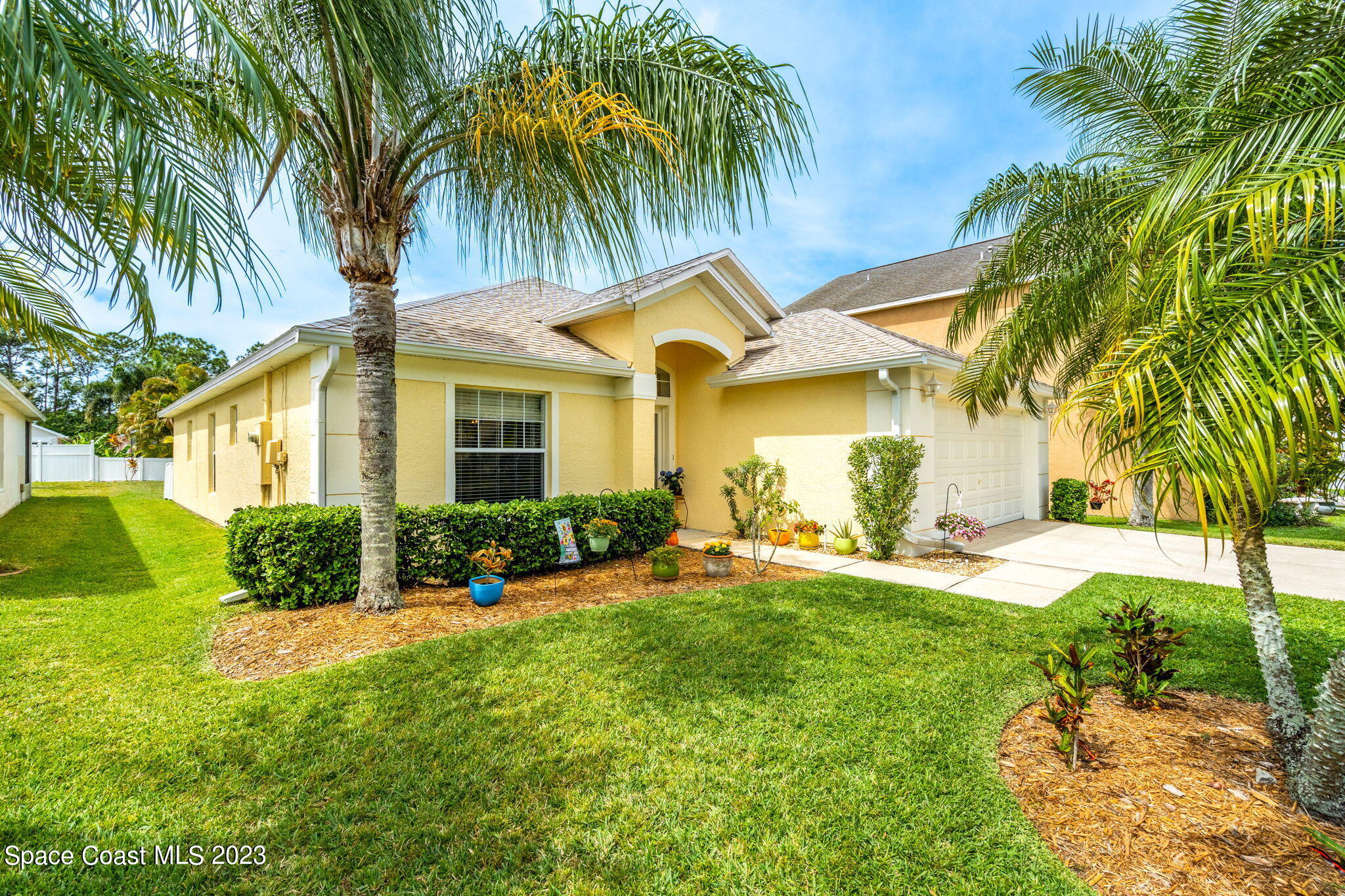 a front view of house with yard and green space