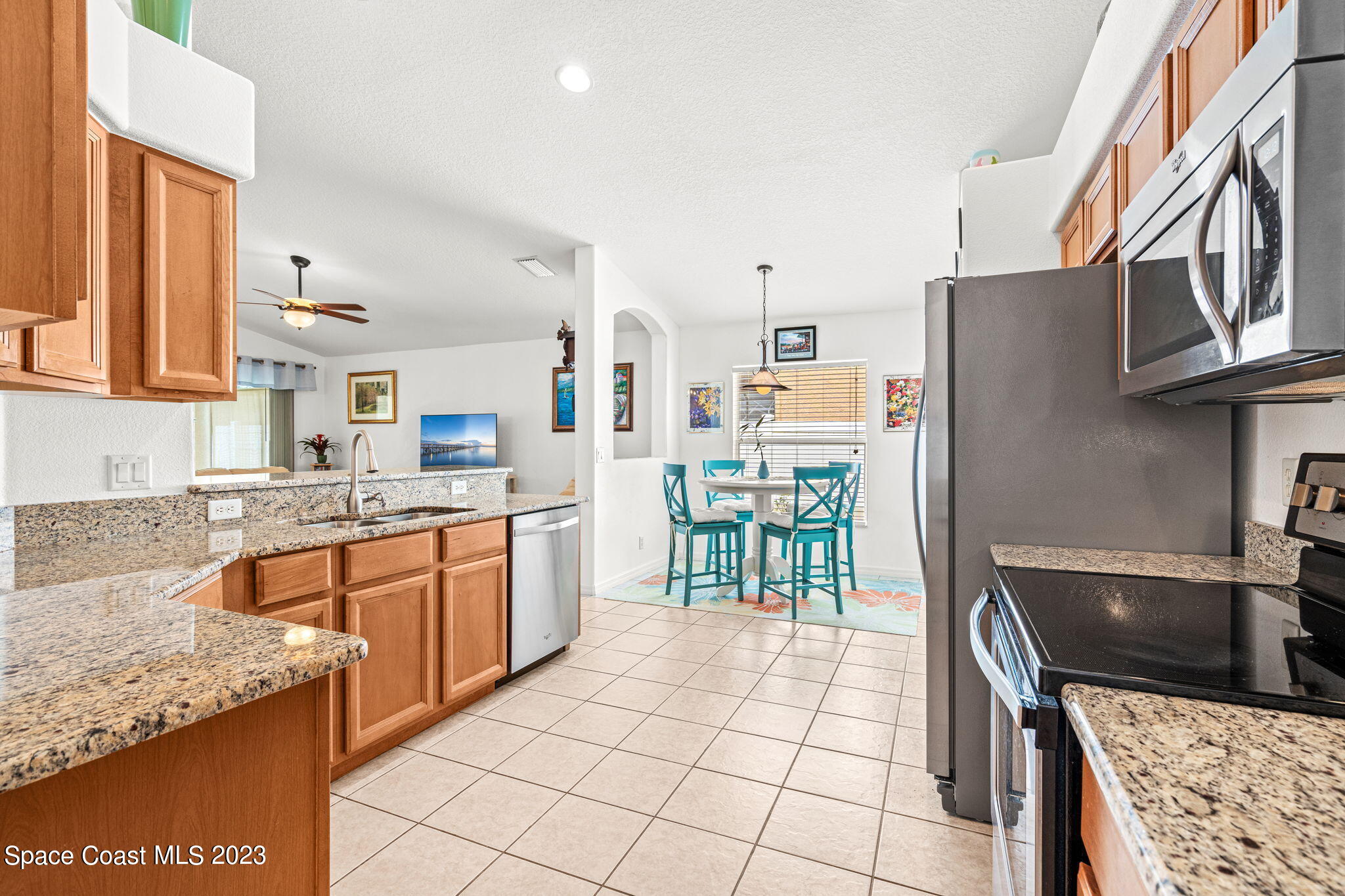 2463 Glasbern Circle Melbourne, FL 32904 - Photo 10 of 57 a kitchen with stainless steel appliances granite countertop a refrigerator and a stove top oven