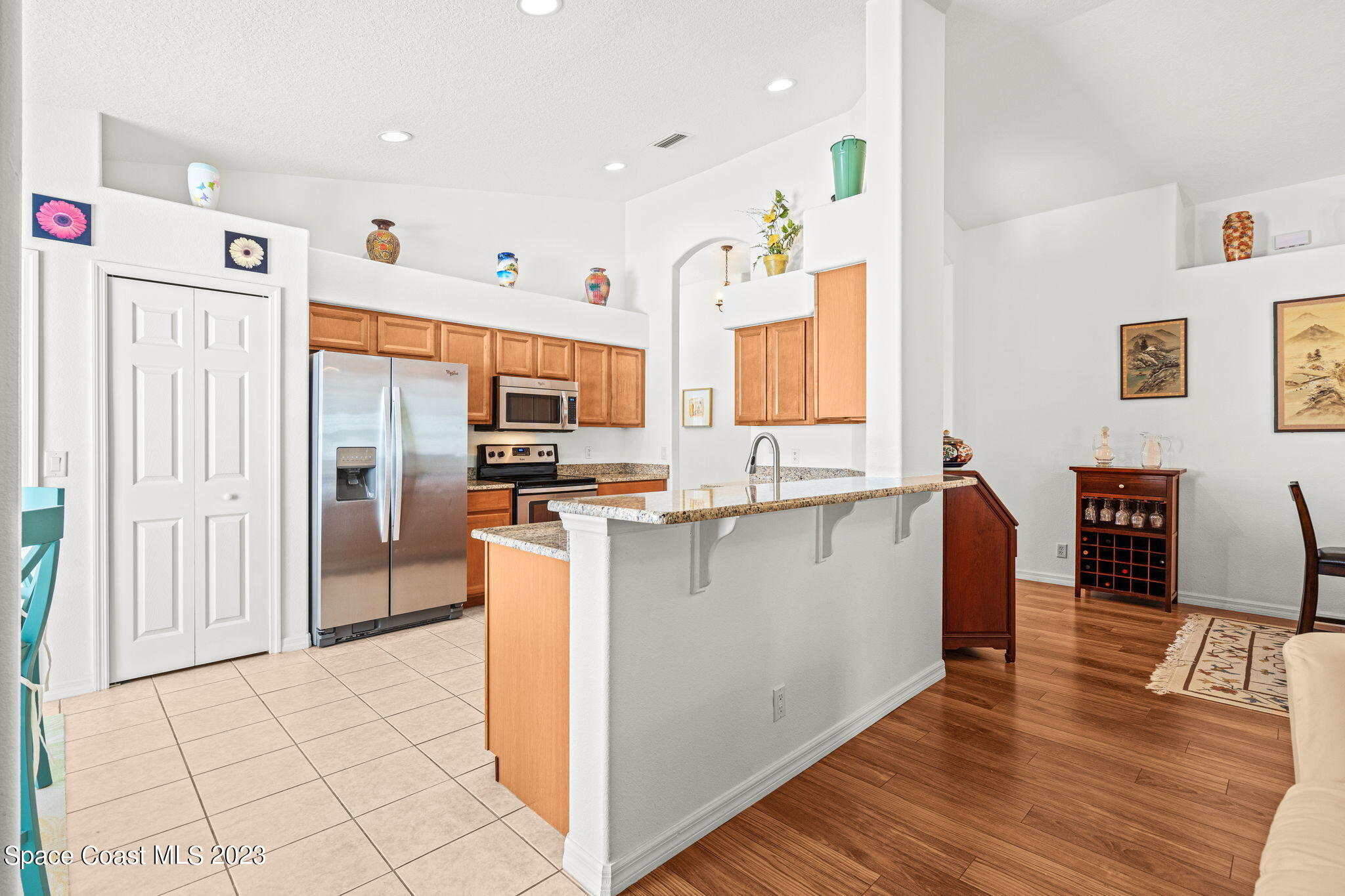 2463 Glasbern Circle Melbourne, FL 32904 - Photo 11 of 57 a kitchen with stainless steel appliances a refrigerator and a stove top oven