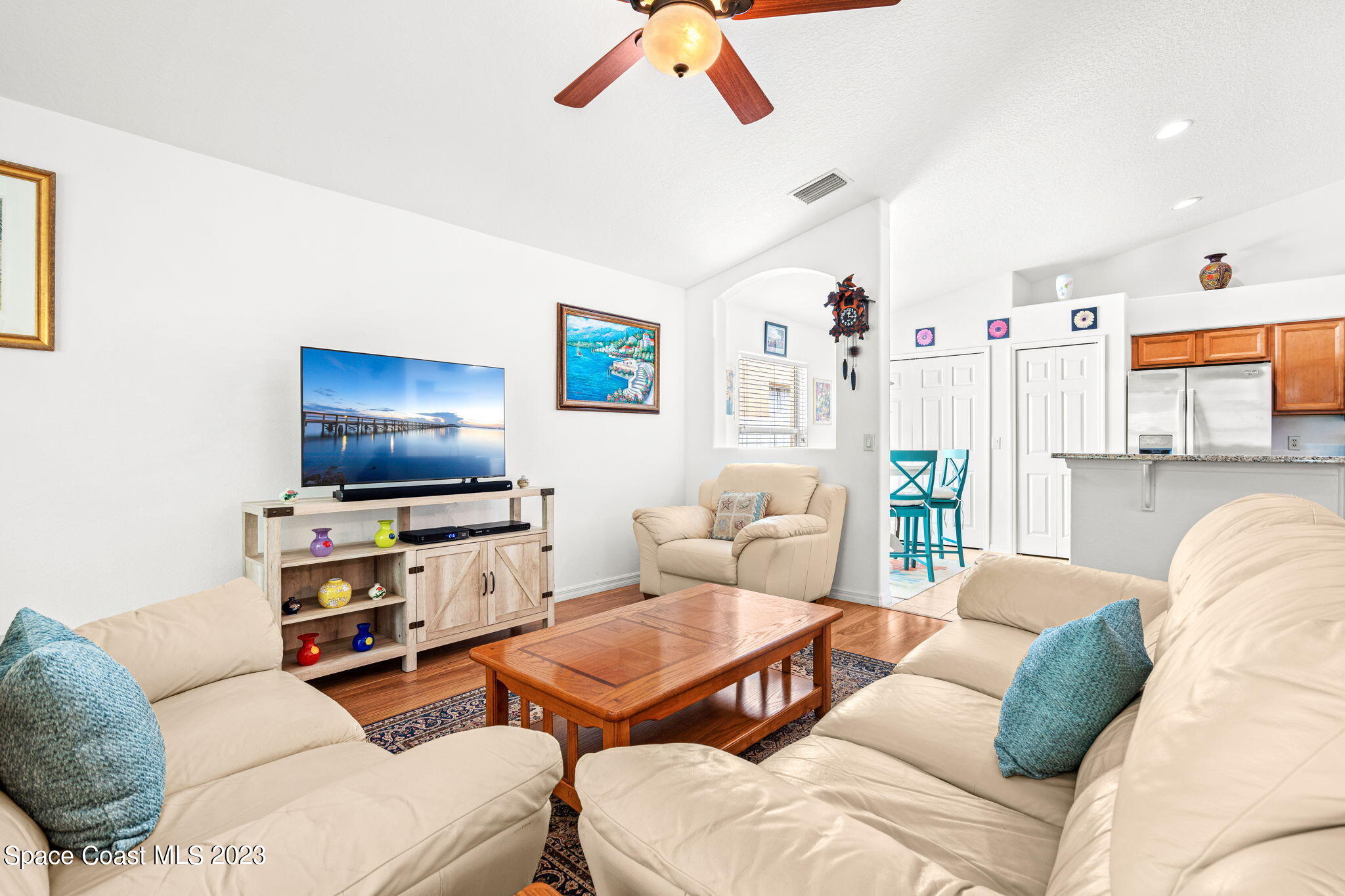2463 Glasbern Circle Melbourne, FL 32904 - Photo 13 of 57 a living room with furniture and a flat screen tv
