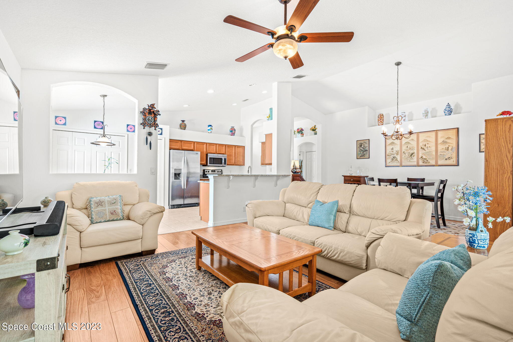 2463 Glasbern Circle Melbourne, FL 32904 - Photo 56 of 57 a living room with furniture ceiling fan and a rug