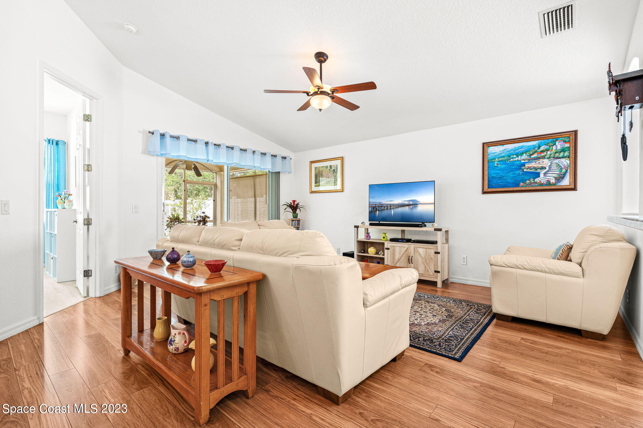 2463 Glasbern Circle Melbourne, FL 32904 - Photo 14 of 57 a living room with furniture and a flat screen tv