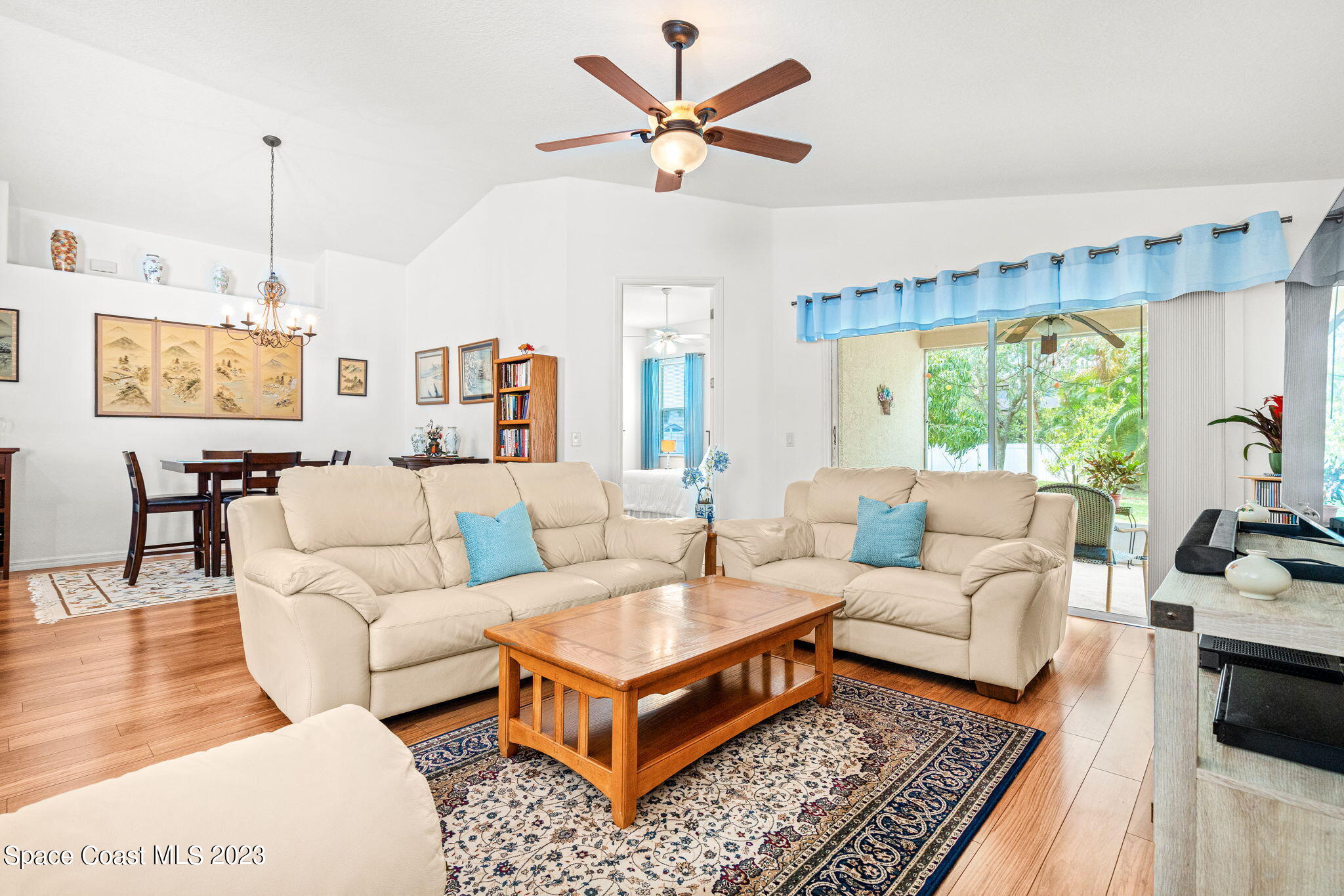 2463 Glasbern Circle Melbourne, FL 32904 - Photo 15 of 57 a living room with furniture a table and a large window