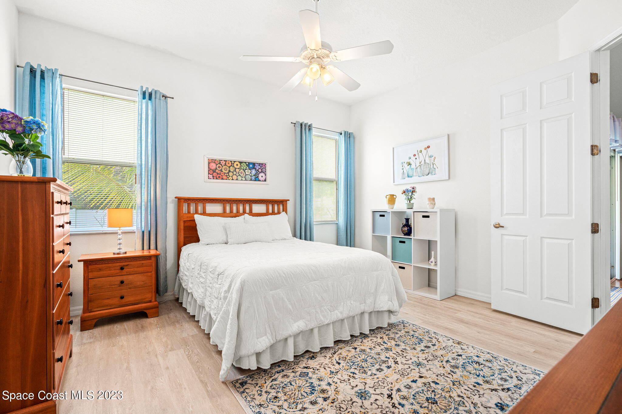 2463 Glasbern Circle Melbourne, FL 32904 - Photo 17 of 57 a bedroom with a large bed and a chandelier