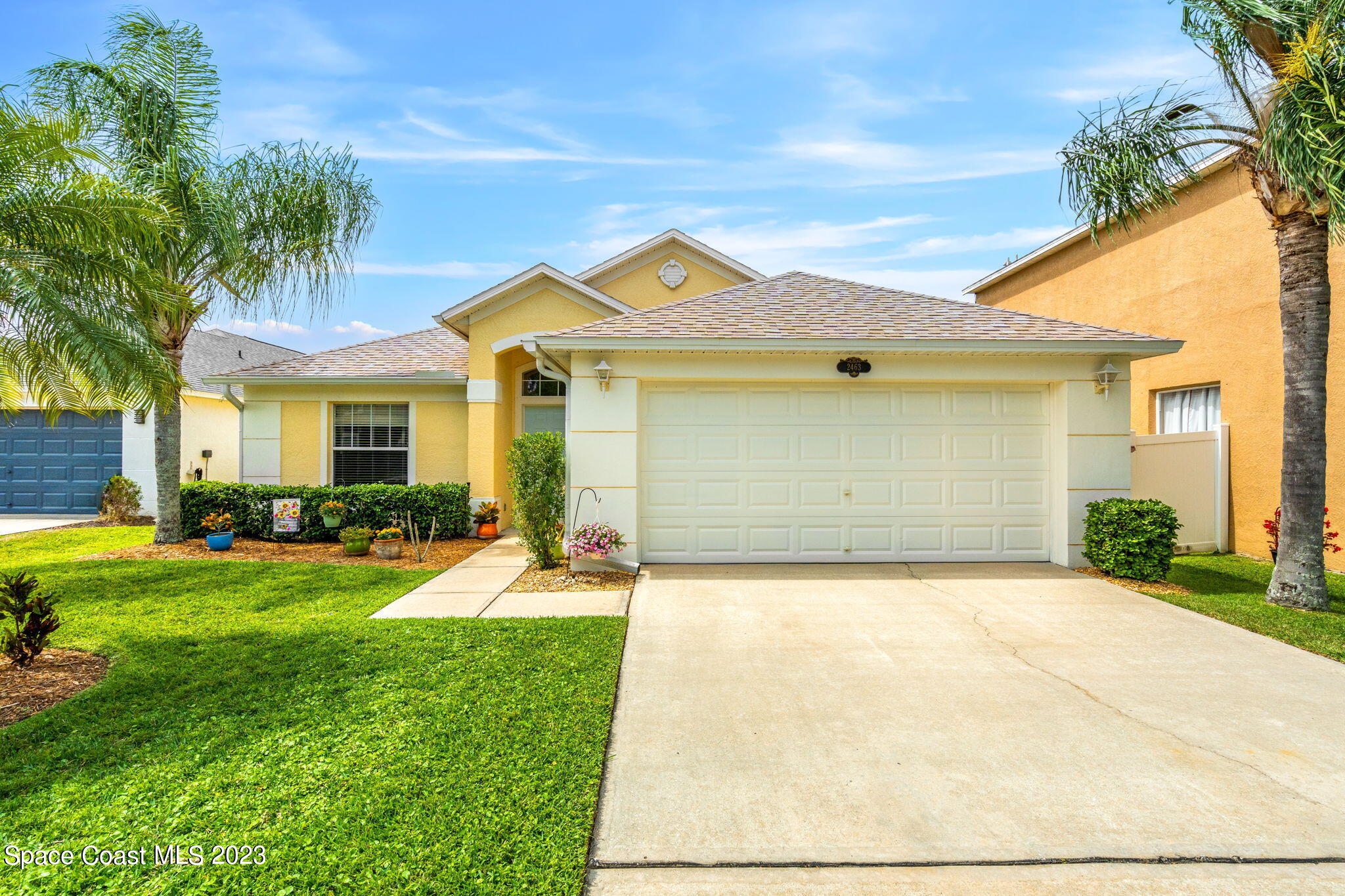2463 Glasbern Circle Melbourne, FL 32904 - Photo 2 of 57 a front view of a house with yard and garage