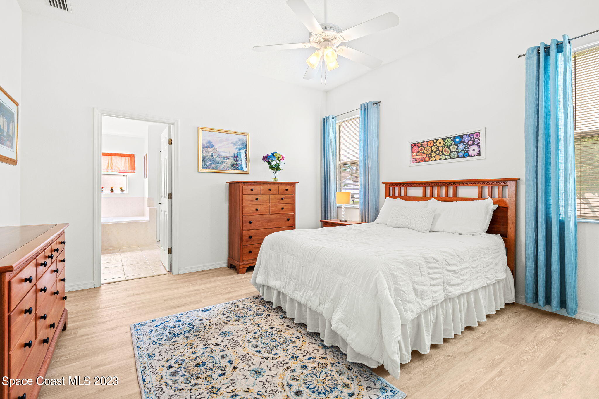 2463 Glasbern Circle Melbourne, FL 32904 - Photo 18 of 57 a bedroom with a large bed and a chandelier