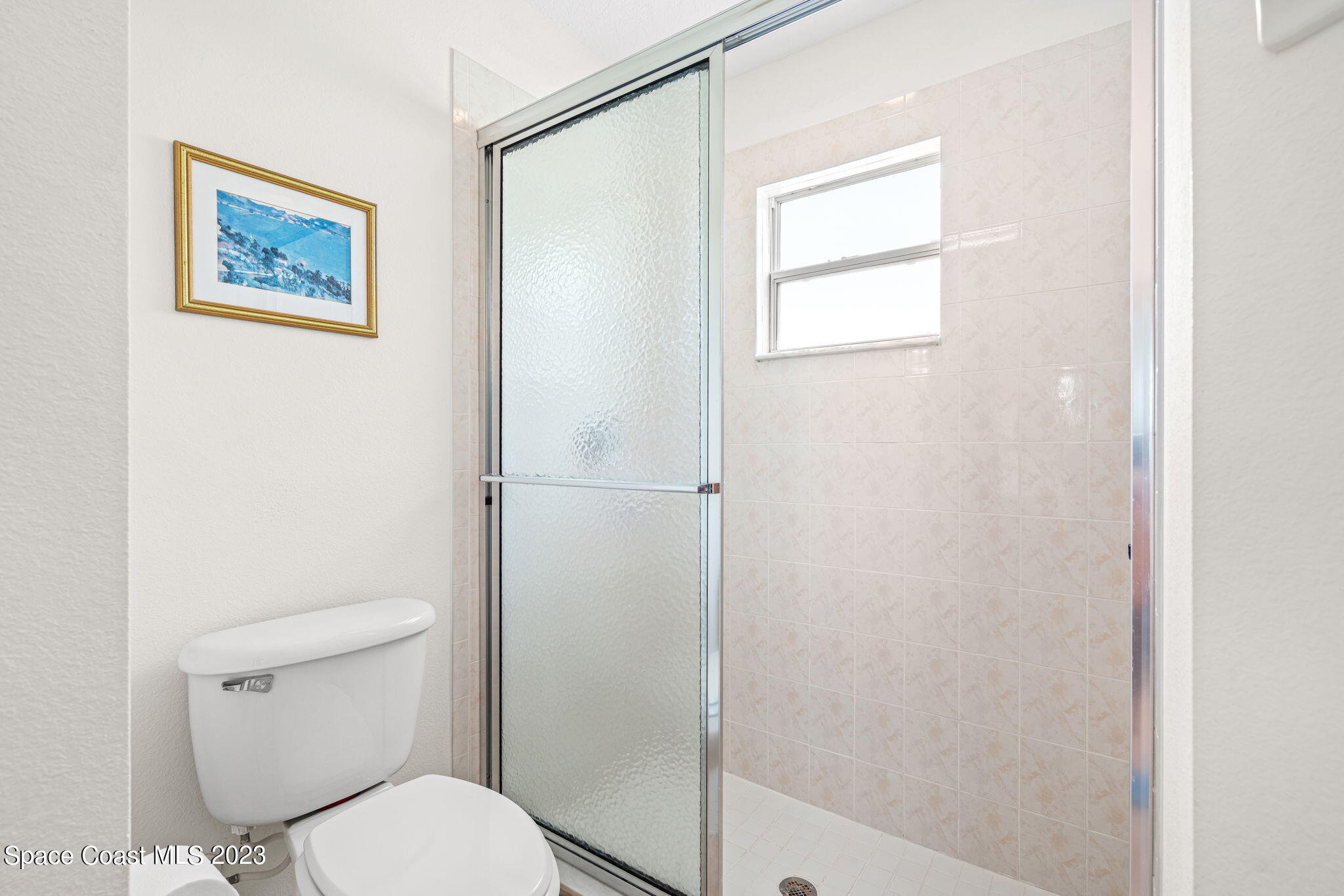 2463 Glasbern Circle Melbourne, FL 32904 - Photo 22 of 57 a white toilet sitting next to a bathroom sink