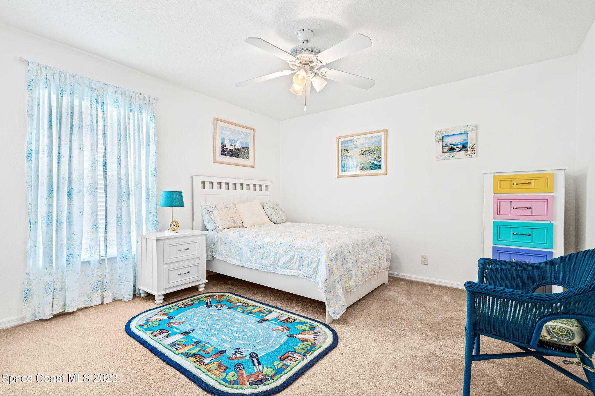 2463 Glasbern Circle Melbourne, FL 32904 - Photo 23 of 57 a bedroom with a bed and a table in it