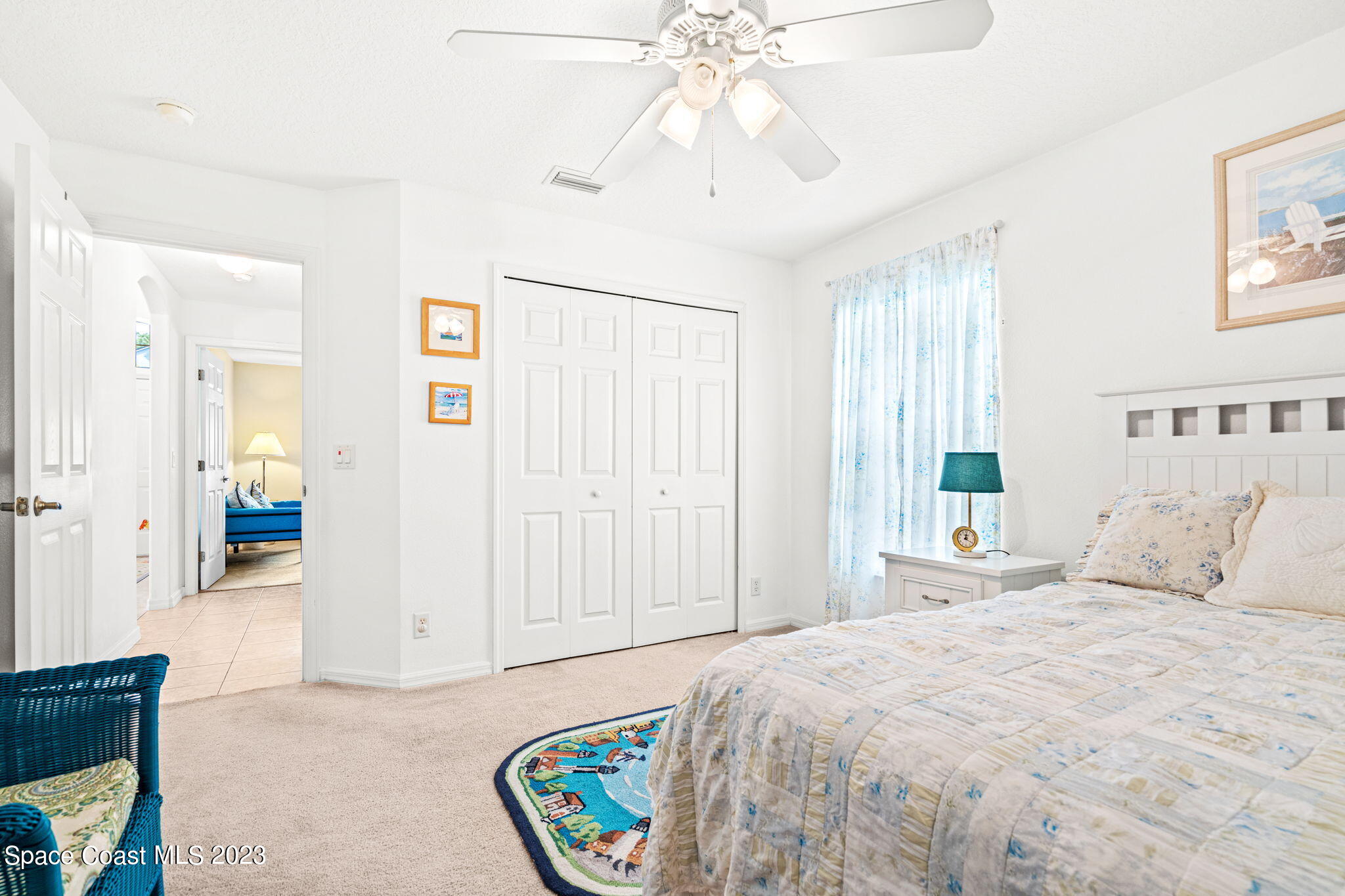 2463 Glasbern Circle Melbourne, FL 32904 - Photo 24 of 57 a bedroom with a bed and a chandelier