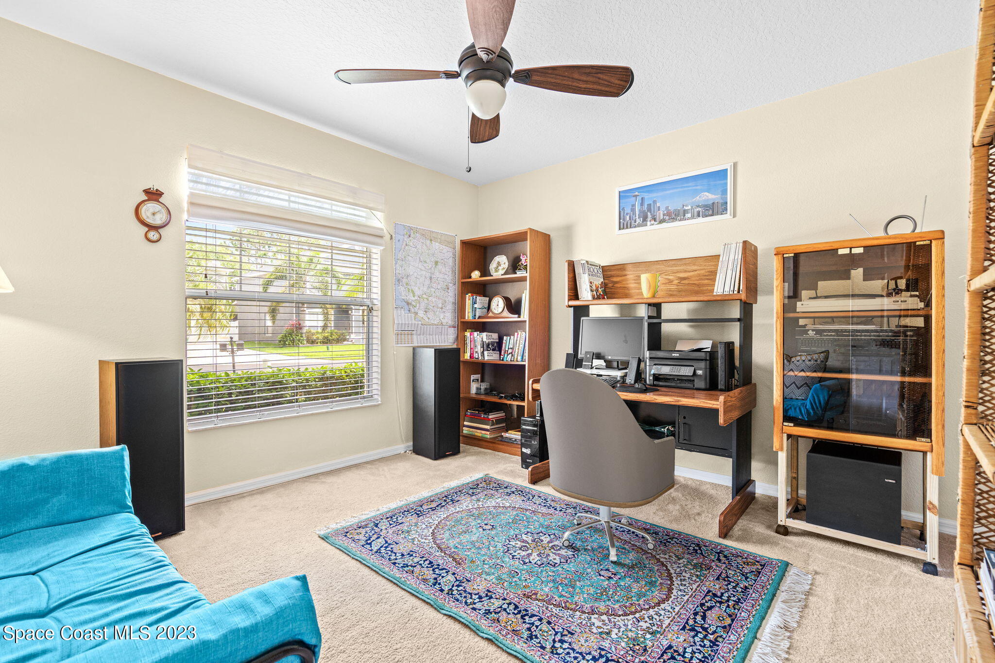 2463 Glasbern Circle Melbourne, FL 32904 - Photo 26 of 57 a living room with furniture and a book shelf