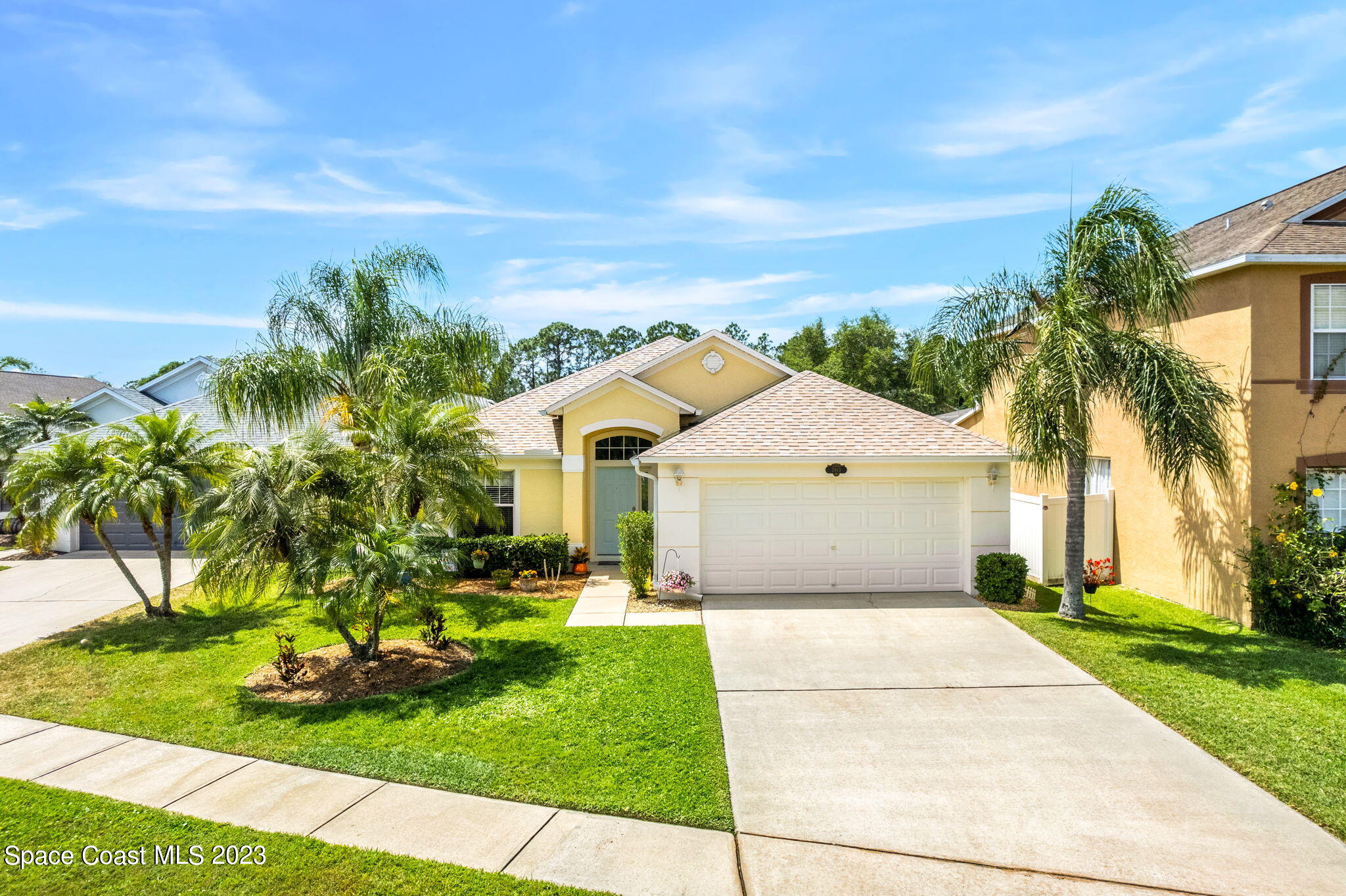 2463 Glasbern Circle Melbourne, FL 32904 - Photo 36 of 57 a front view of a house with a garden and yard