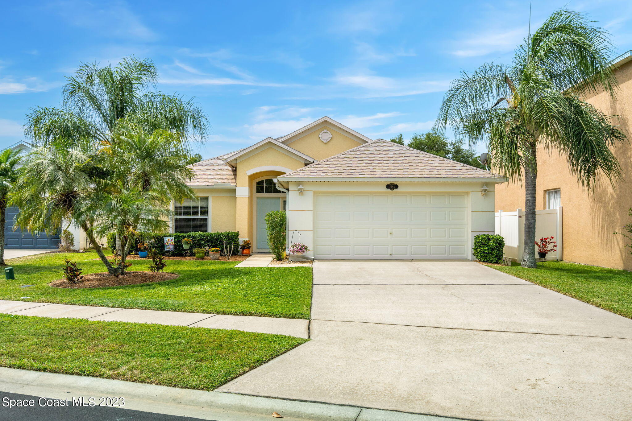 2463 Glasbern Circle Melbourne, FL 32904 - Photo 37 of 57 a front view of a house with a garden and trees