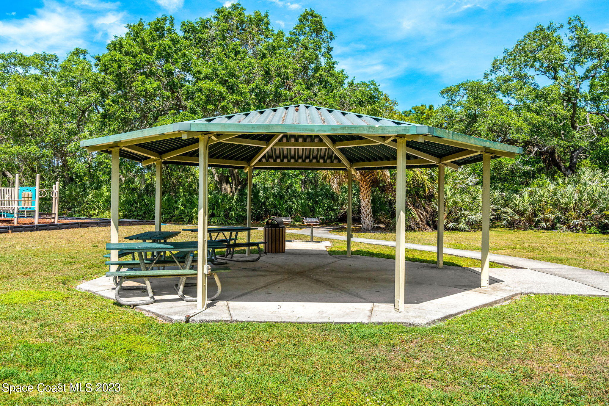 2463 Glasbern Circle Melbourne, FL 32904 - Photo 43 of 57 a view of a chair and table with the small garden