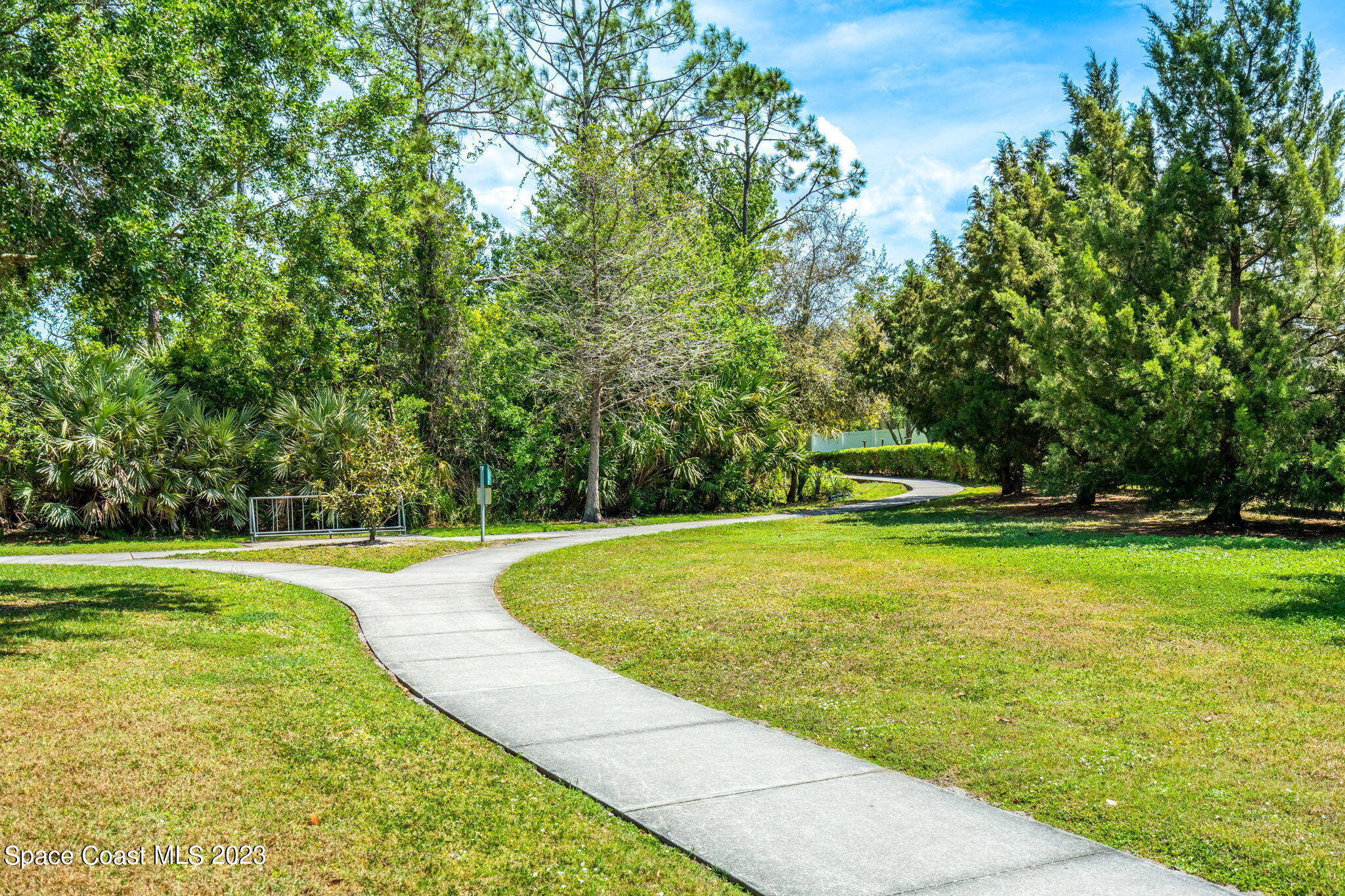 2463 Glasbern Circle Melbourne, FL 32904 - Photo 48 of 57 a view of a swimming pool with a yard and trees