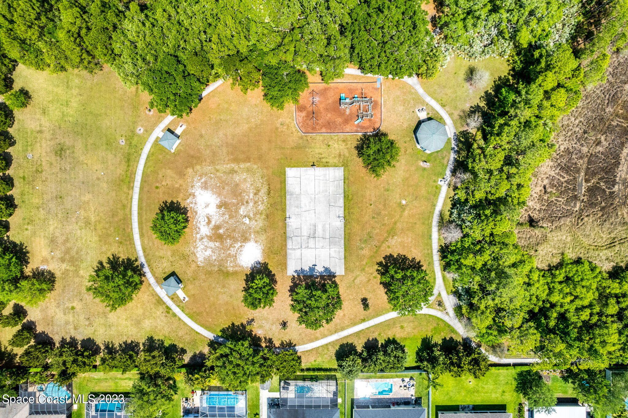 2463 Glasbern Circle Melbourne, FL 32904 - Photo 53 of 57 an aerial view of a residential houses with yard and swimming pool