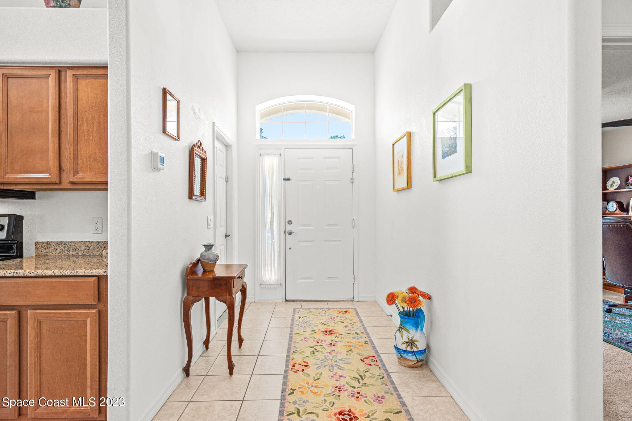 2463 Glasbern Circle Melbourne, FL 32904 - Photo 5 of 57 a hallway with table and couch