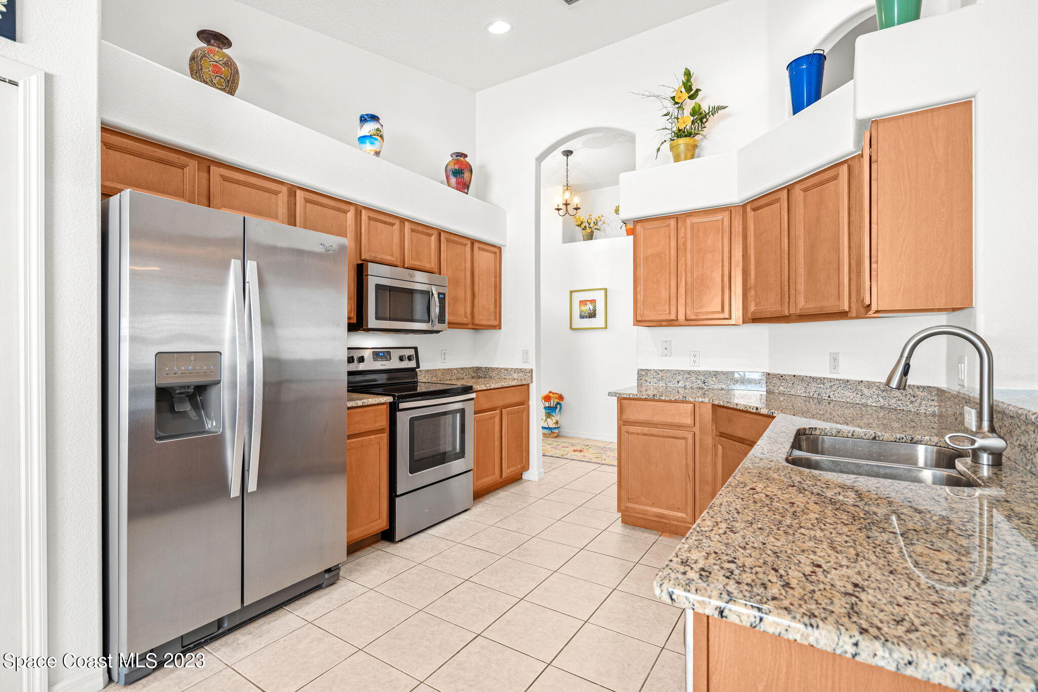 2463 Glasbern Circle Melbourne, FL 32904 - Photo 8 of 57 a kitchen with stainless steel appliances granite countertop a refrigerator and a sink