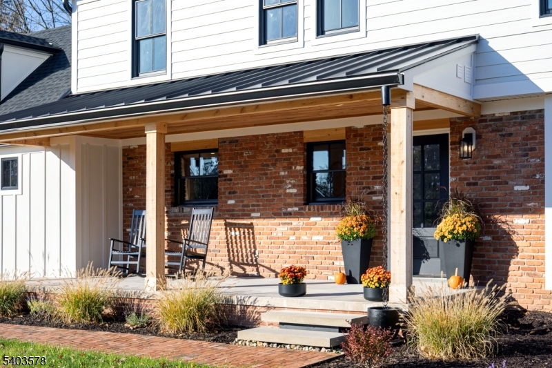 front view of the house with potted plants