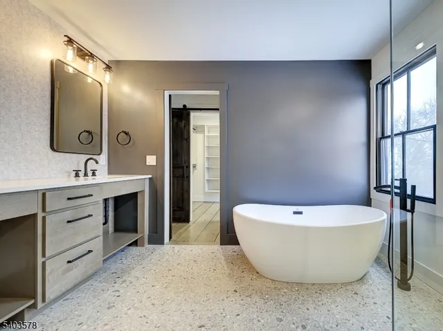 a spacious bathroom with a bathtub and sink