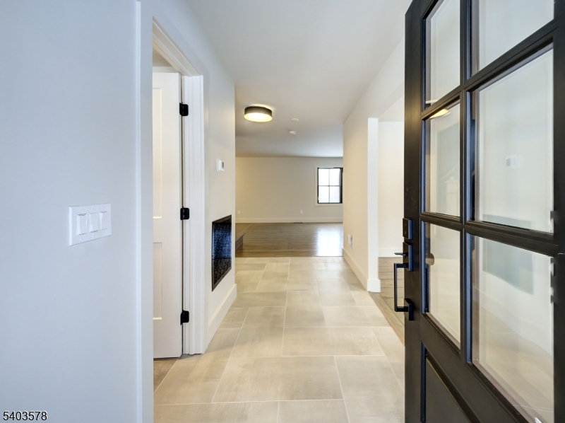 113 Cole Road Flemington, NJ 08822 - Photo 3 of 31 a view of a hallway with wooden floor and staircase