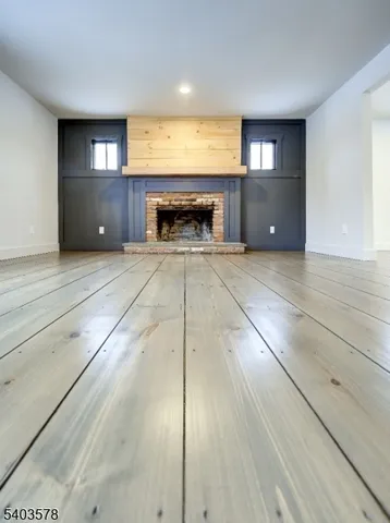 a view of an empty room and fire place