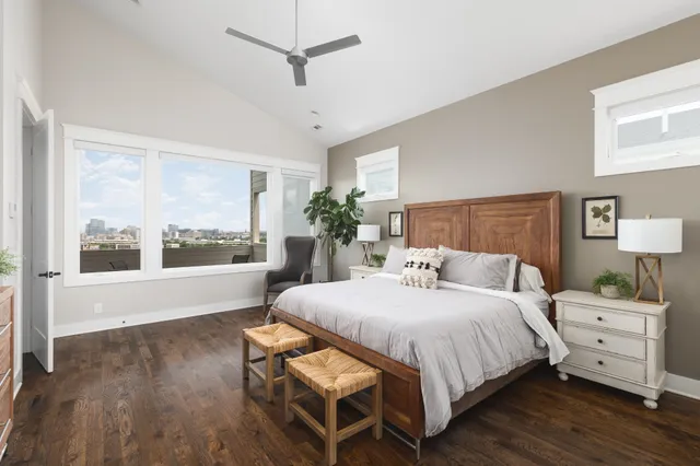 a bedroom with a large bed and a large window
