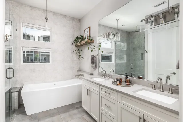 a bathroom with a double vanity sink mirror and double