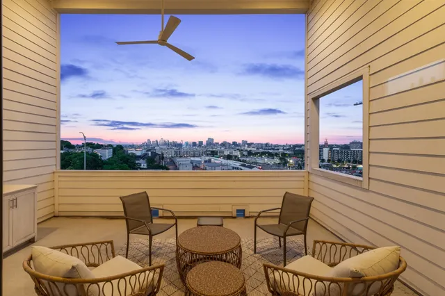 a view of a balcony with chairs and a table