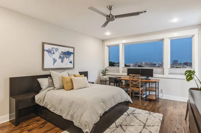 a bedroom with a bed a table and chair